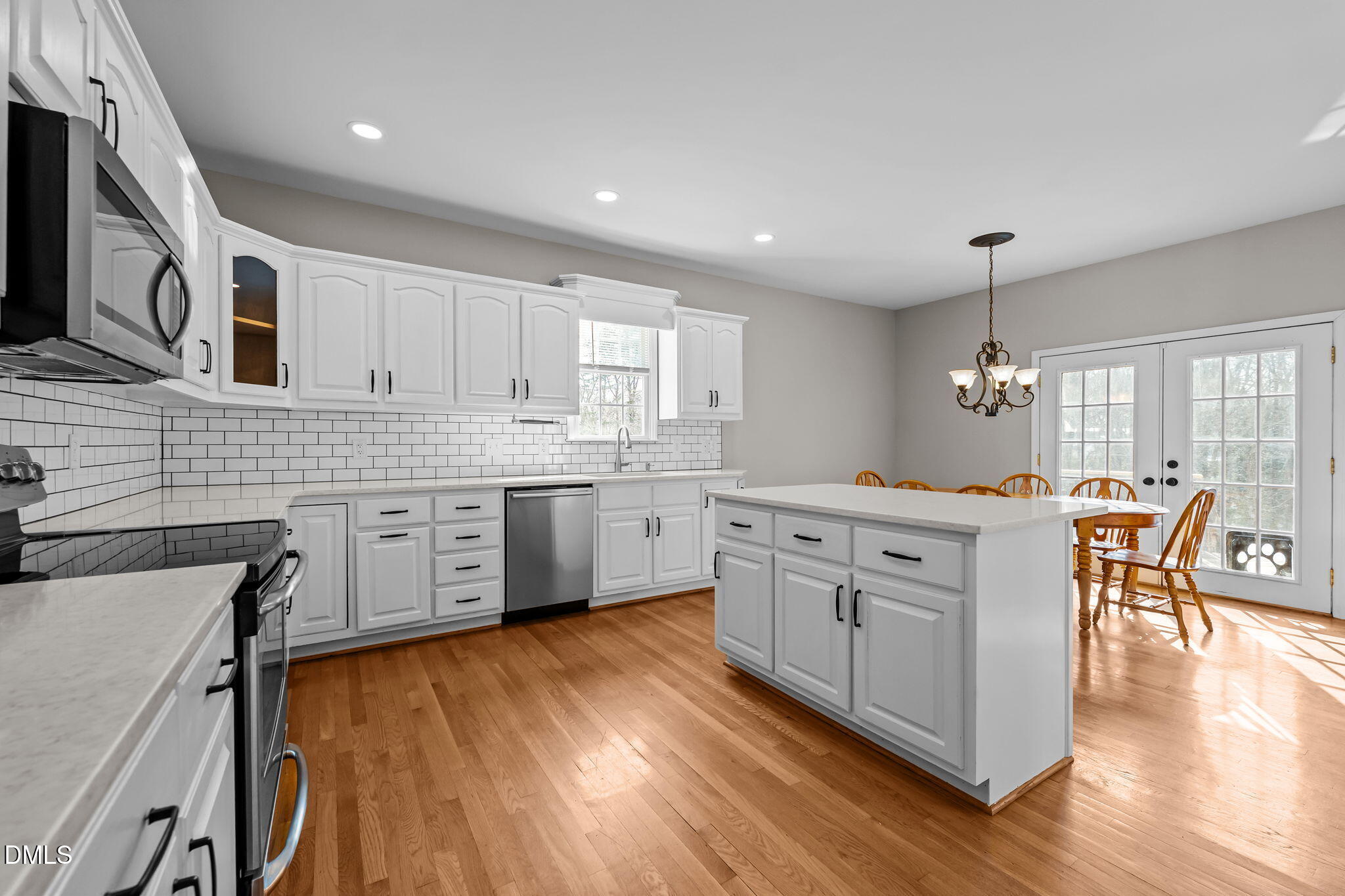 2327 Olde Spring Court Graham, NC 27253 - Photo 19 of 49 a kitchen with cabinets wooden floor and a sink