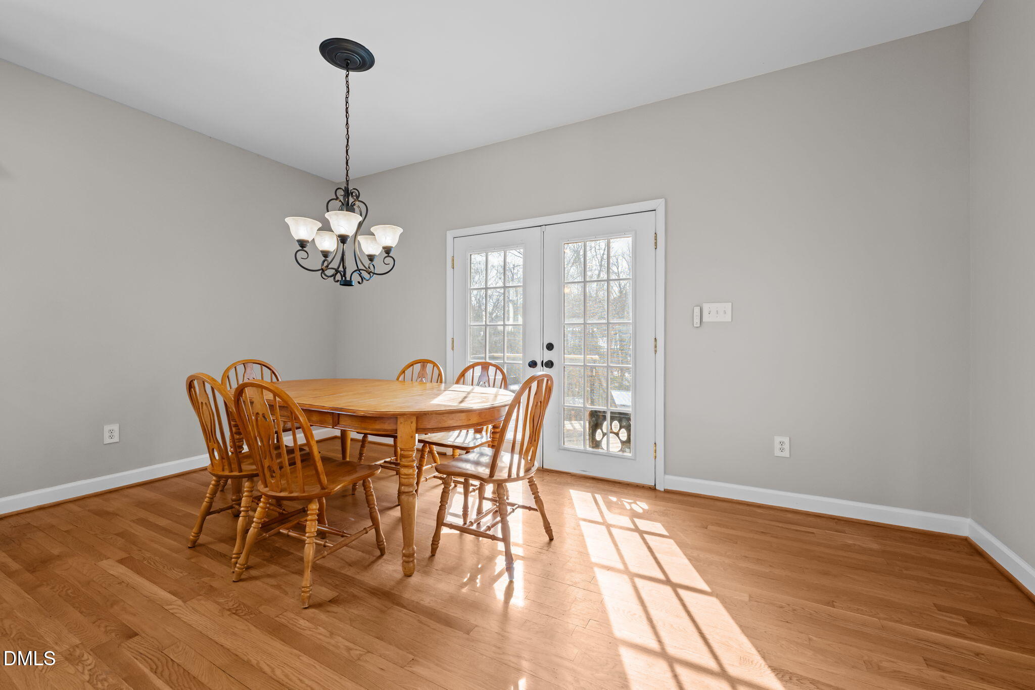 2327 Olde Spring Court Graham, NC 27253 - Photo 20 of 49 a dining room with furniture a chandelier and wooden floor