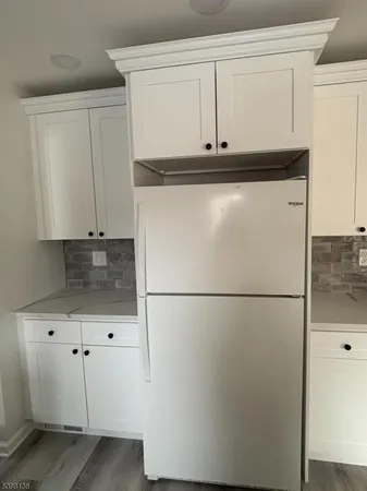 a white refrigerator freezer sitting in a kitchen