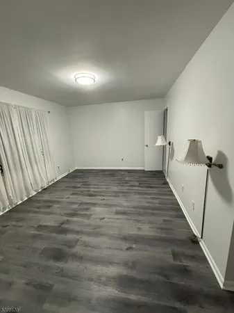 a view of room with wooden floor