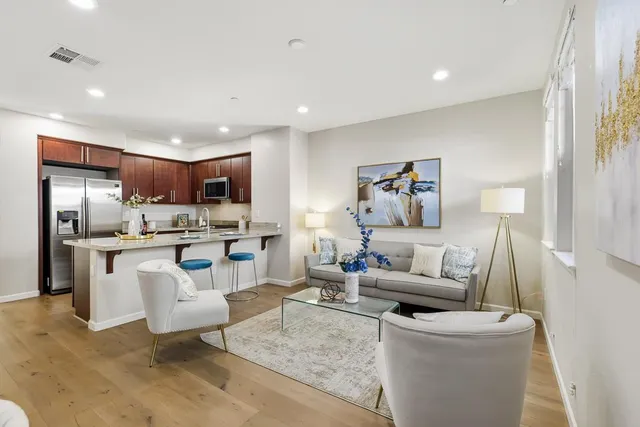 a living room with furniture and kitchen view