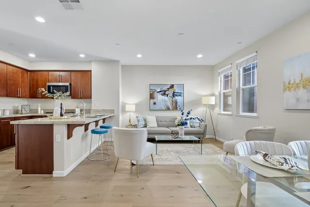 a living room with granite countertop furniture and a kitchen view
