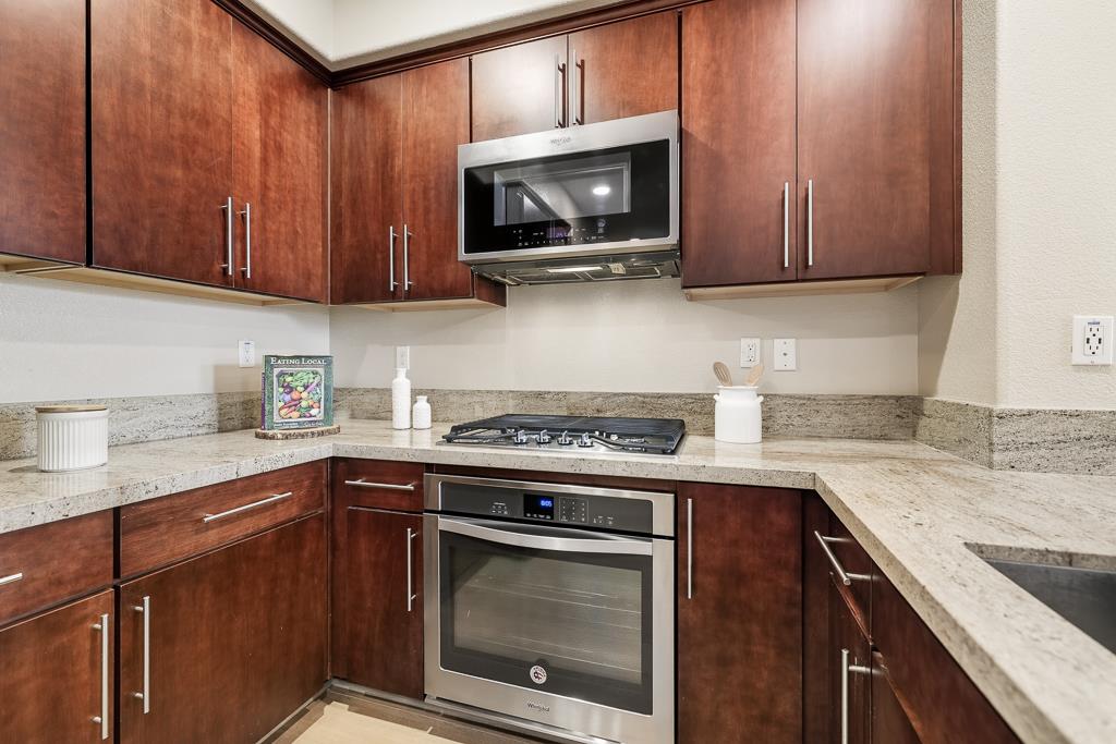 1036 Onofrio Lane, Unit 6 San Jose, CA 95133 - Photo 16 of 50 a kitchen with stainless steel appliances granite countertop wooden cabinets stove top oven and sink