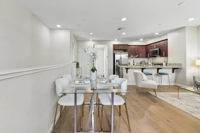 a view of a dining room with furniture and wooden floor
