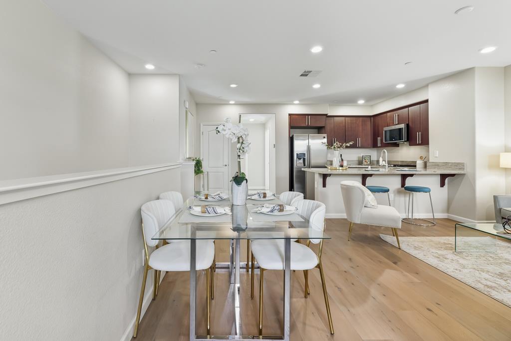 1036 Onofrio Lane, Unit 6 San Jose, CA 95133 - Photo 21 of 50 a view of a dining room with furniture and wooden floor