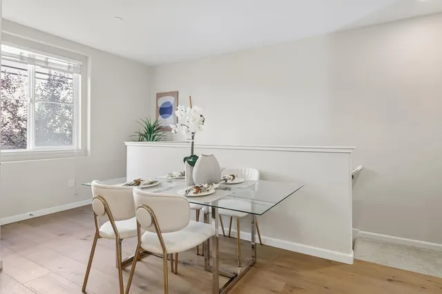 a view of a dining room with furniture and a window