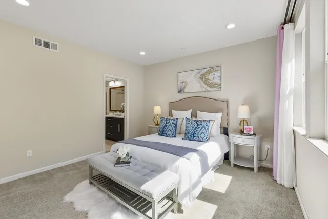 a bedroom with a bed and a table in it