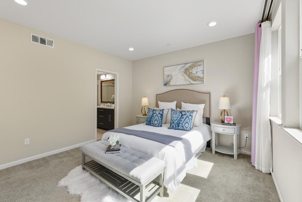 1036 Onofrio Lane, Unit 6 San Jose, CA 95133 - Photo 24 of 50 a bedroom with a bed and a table in it