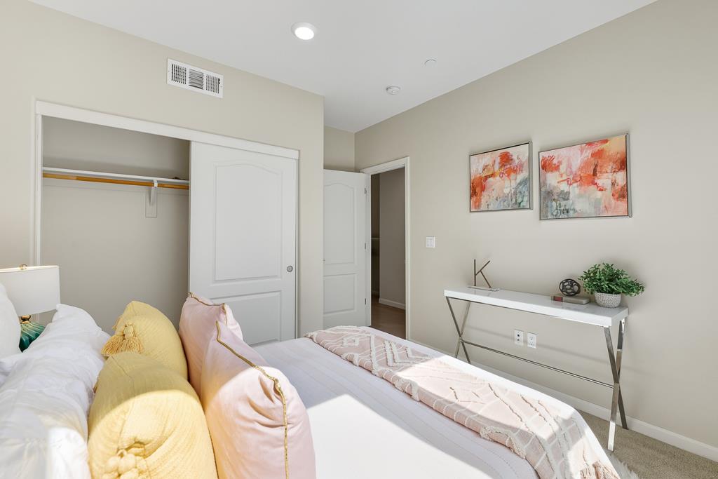 1036 Onofrio Lane, Unit 6 San Jose, CA 95133 - Photo 30 of 50 a bedroom with a bed and a painting on the wall