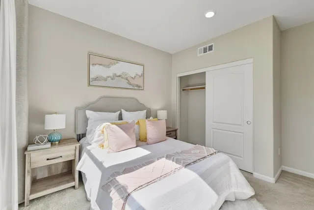 a bedroom with a bed and a painting on the wall