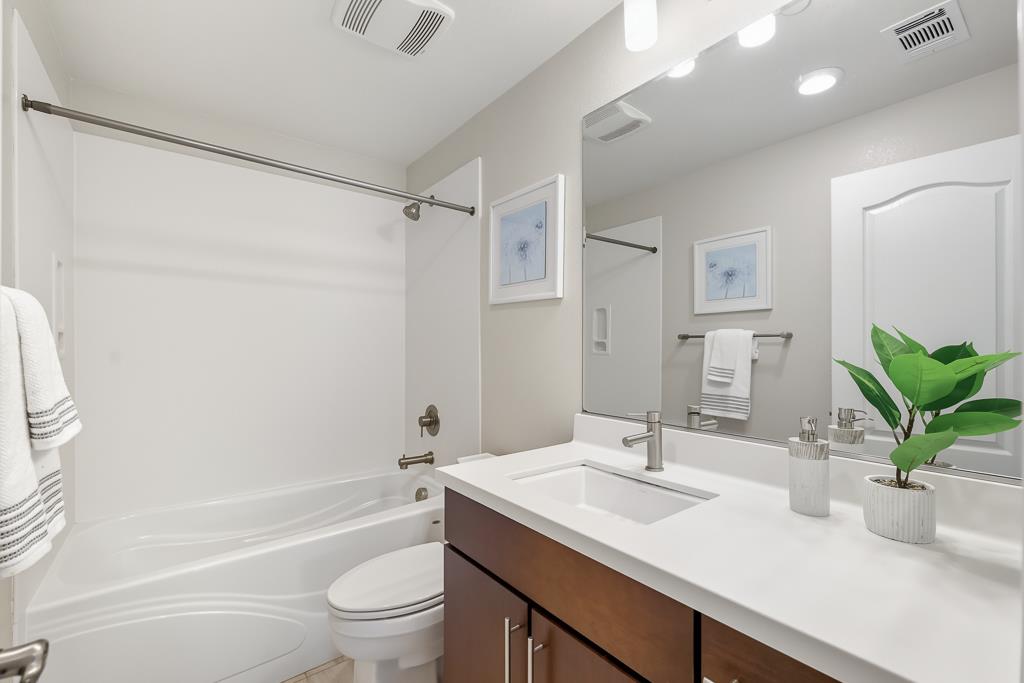 1036 Onofrio Lane, Unit 6 San Jose, CA 95133 - Photo 33 of 50 a bathroom with a granite countertop sink a toilet and a bathtub