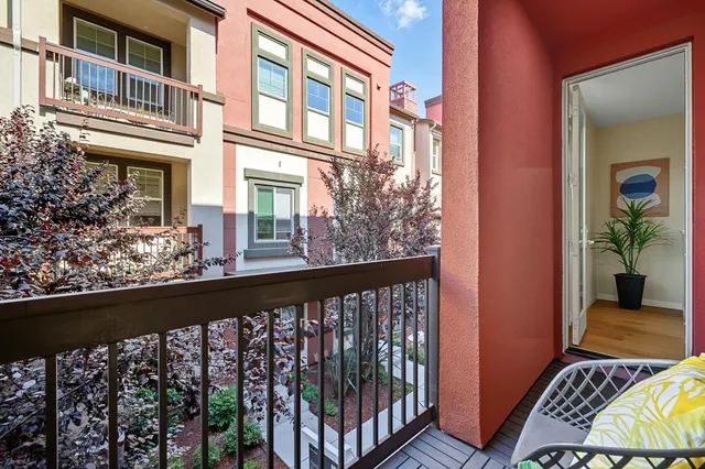 a view of a balcony with wooden floor and fence