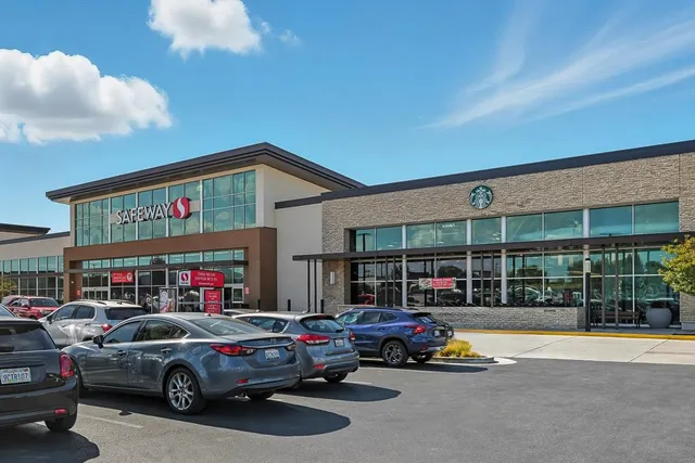 a view of a cars park in front of a building