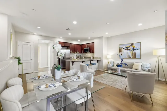 a living room with lots of furniture and kitchen view