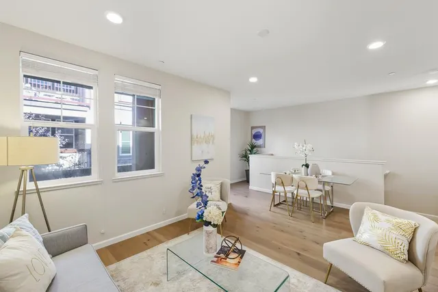 a living room with furniture and next to a window