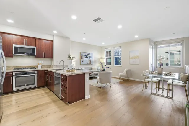 a kitchen with sink a microwave and cabinets
