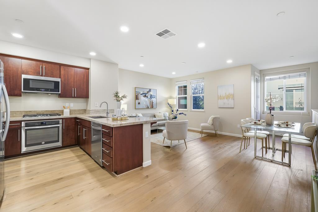 1036 Onofrio Lane, Unit 6 San Jose, CA 95133 - Photo 9 of 50 a kitchen with sink a microwave and cabinets