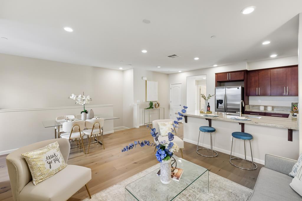 1036 Onofrio Lane, Unit 6 San Jose, CA 95133 - Photo 10 of 50 a living room with stainless steel appliances furniture a rug and a kitchen view