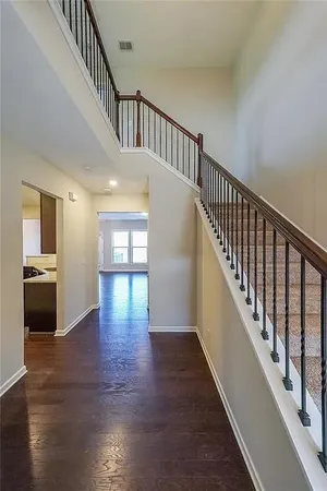 a view of staircase with wooden floor and a floor to ceiling window