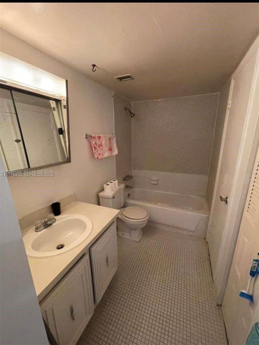 496 Northwest 165th Street, Unit D611 Miami, FL 33169 - Photo 5 of 8 a bathroom with a sink a toilet and shower