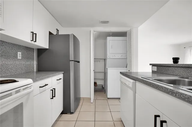 a kitchen with white cabinets and white appliances