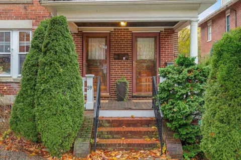 a front view of a house with plants