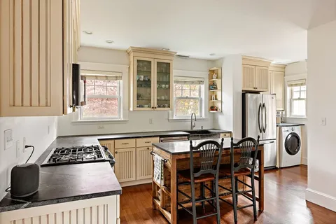 a kitchen with granite countertop a stove and a sink