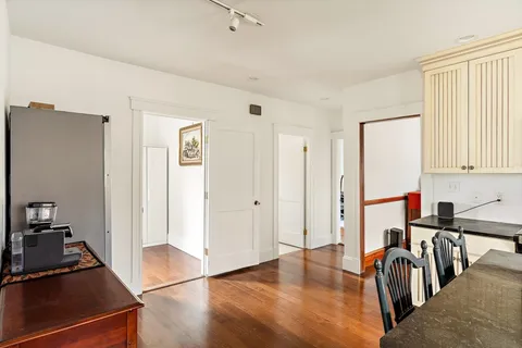 a view of a kitchen with dining area closet and windows