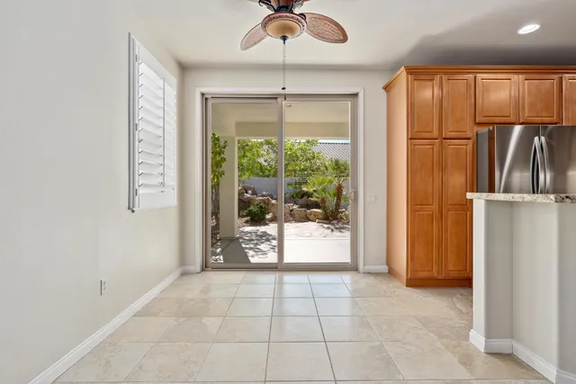 a view of a kitchen with a refrigerator cabinets and a floor to ceiling window