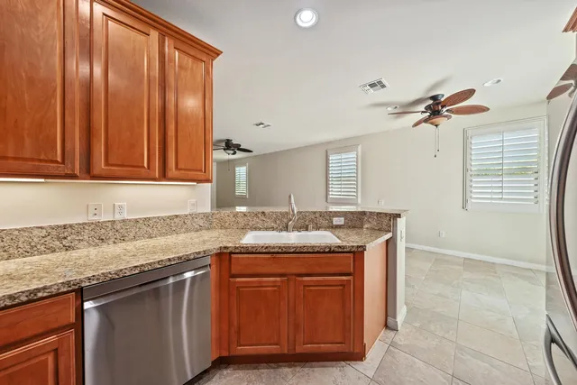 a kitchen with granite countertop a sink and a stove