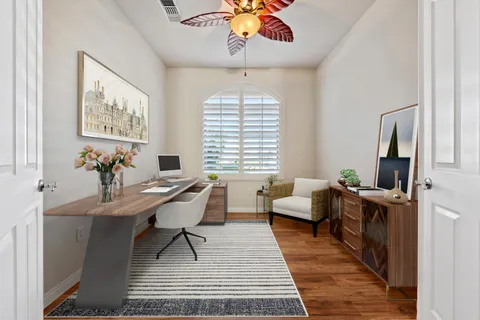a living room with furniture a chandelier and a window