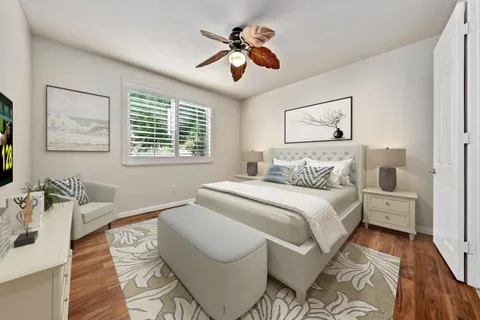 a spacious bedroom with a bed and a chandelier