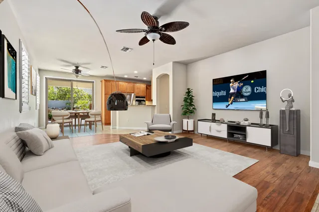 a living room with furniture flat screen tv and a large window