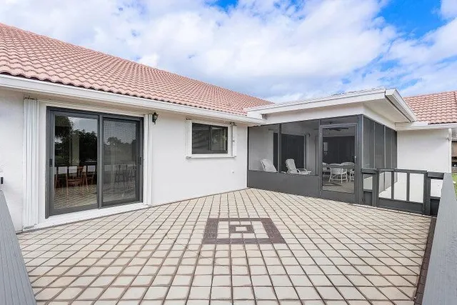 a view of a patio with table and chairs