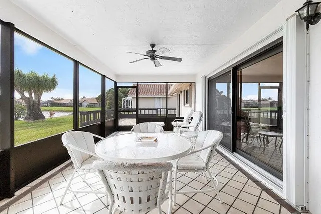 a dining room with furniture a chandelier and garden view