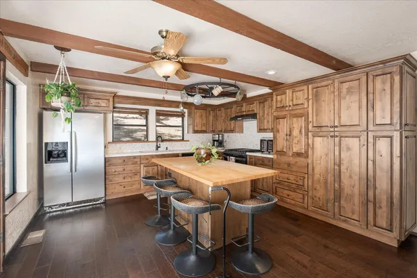a large kitchen with a table and a large window