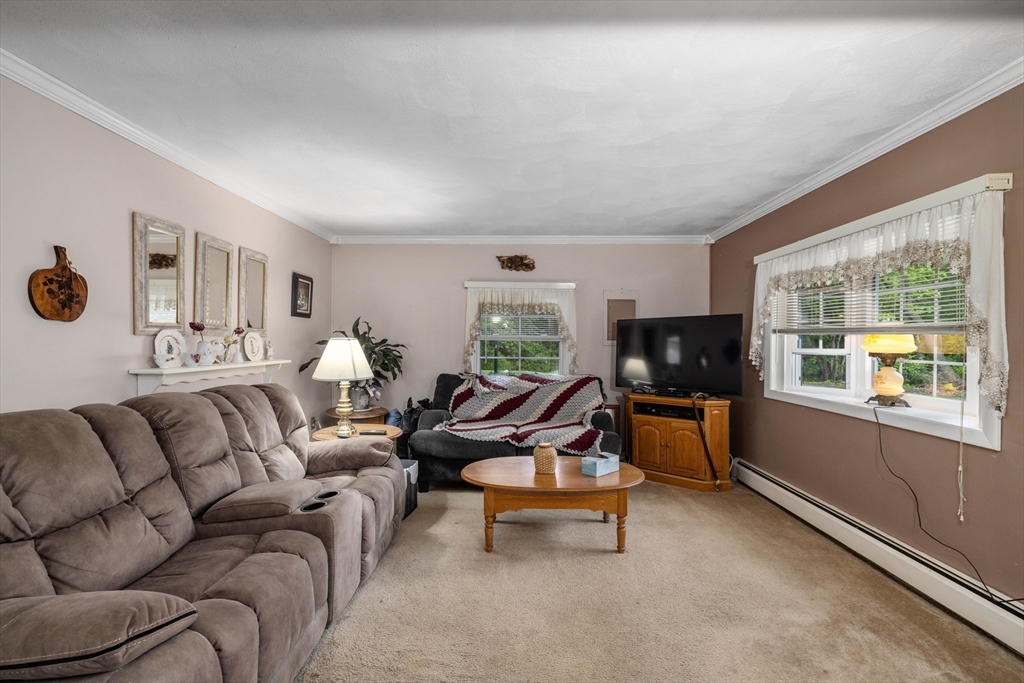 8 Hurlburt Road Billerica, MA 01821 - Photo 5 of 9 a living room with furniture flat screen tv and windows