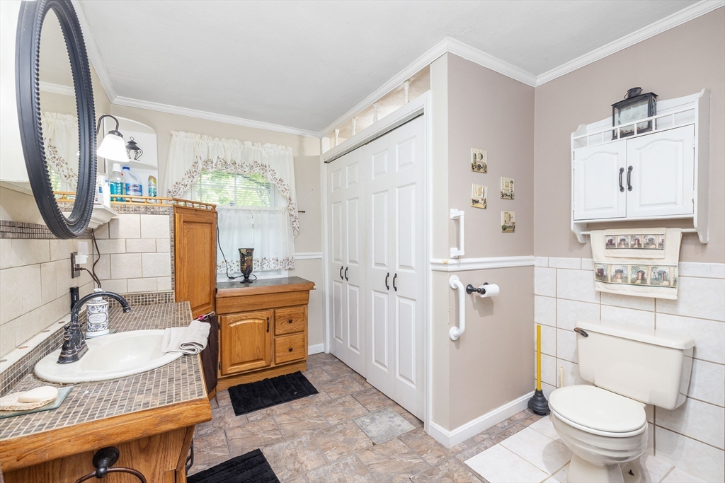 8 Hurlburt Road Billerica, MA 01821 - Photo 6 of 9 a bathroom with a granite countertop sink mirror vanity and toilet