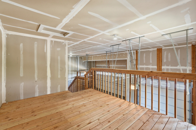 338 Windy Rdg Drive Smithfield, UT 84335 - Photo 52 of 63 Unfinished interior space featuring a wood-finish floor, wood railing, drywall walls, and an unfinished ceiling