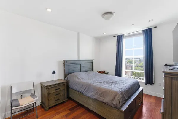 a bedroom with a bed and a window