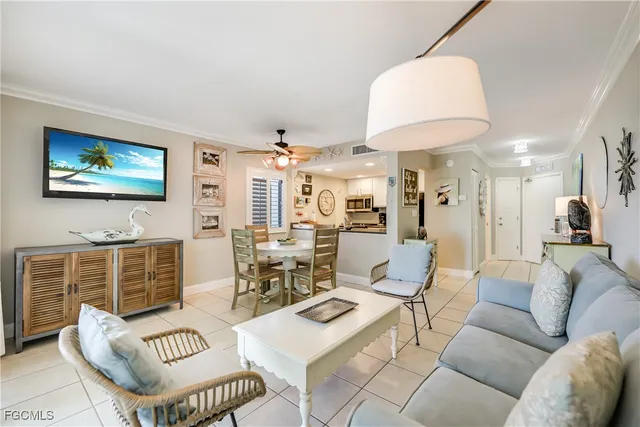 a bedroom with a bed a dresser and a chandelier