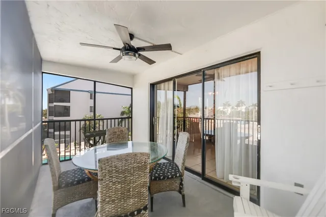 a view of a chair and tables in the balcony