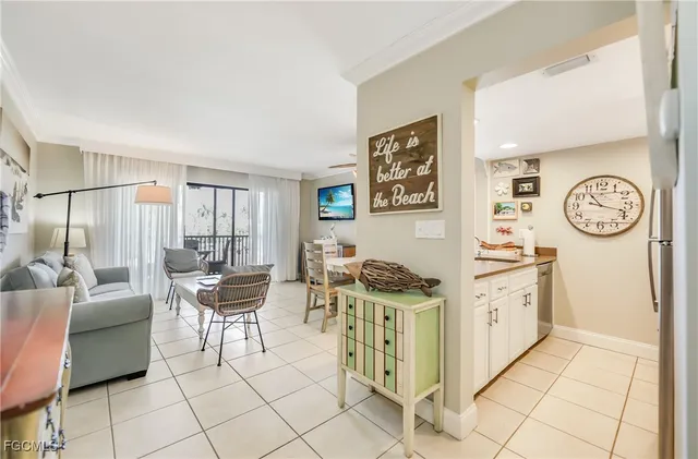 a kitchen with stainless steel appliances a sink a stove and white cabinets with wooden floor