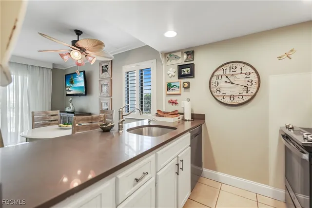 a kitchen with stainless steel appliances granite countertop a sink and a refrigerator