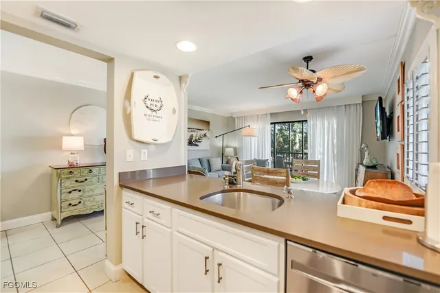 a view of a dining room with furniture a livingroom and chandelier