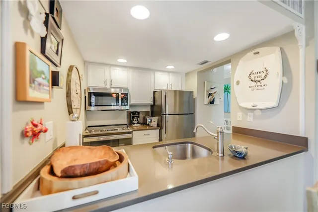 a view of a dining room with furniture and a chandelier