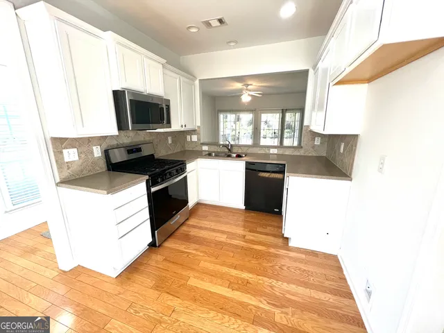 a kitchen with a sink stove and microwave