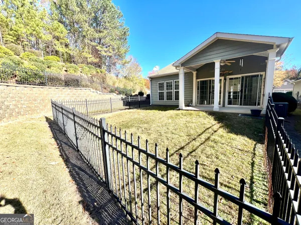 a view of a house with backyard and sitting area