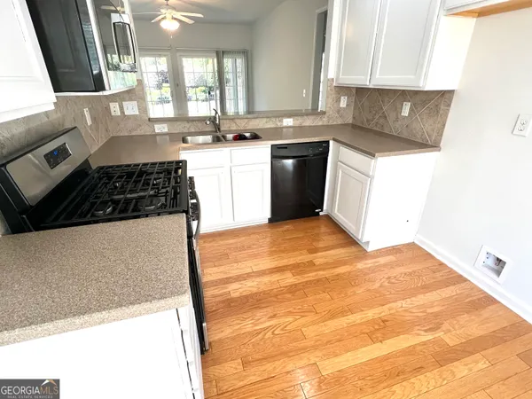 a kitchen with a stove a sink and a microwave