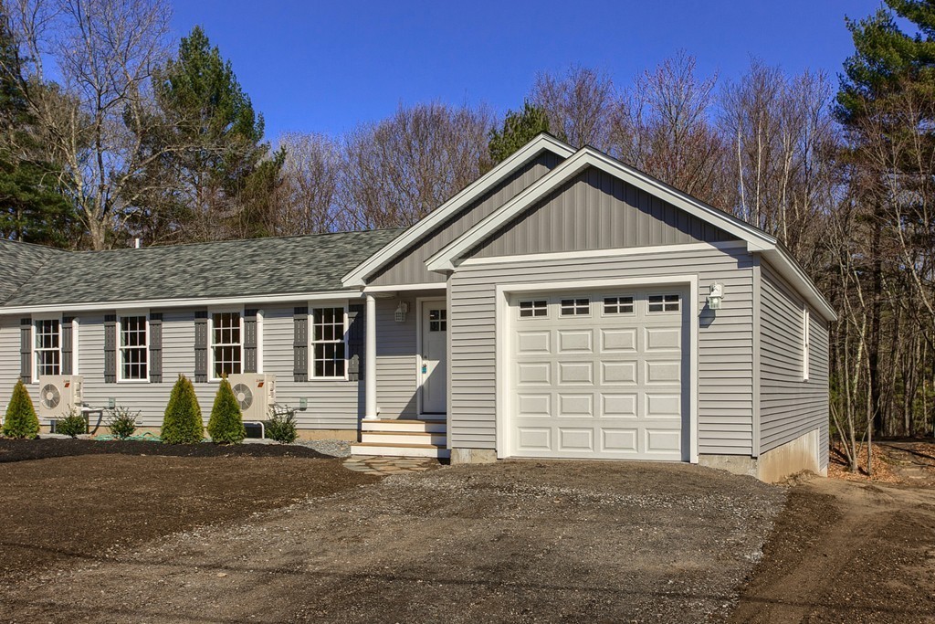 8 Shawnee Road, Unit B Pepperell, MA 01463 - Photo 1 of 18 a front view of a house with a yard and garage
